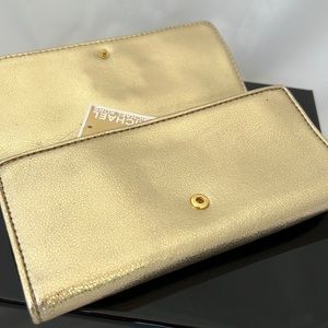 Michael Kors Gold Wallet, new but the gold is scratched on the metal logo.